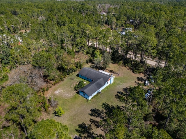 drone / aerial view featuring a forest view