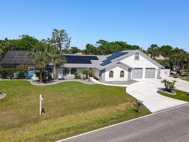 single story home featuring solar panels, a front yard, a lanai, and driveway