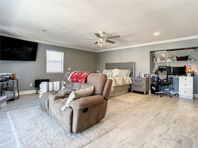 bedroom featuring light wood finished floors, a textured ceiling, baseboards, and crown molding