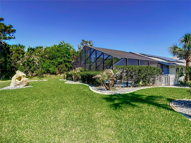 view of yard featuring a lanai and fence