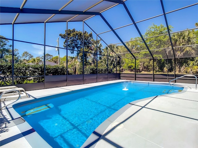 outdoor pool with glass enclosure and a patio