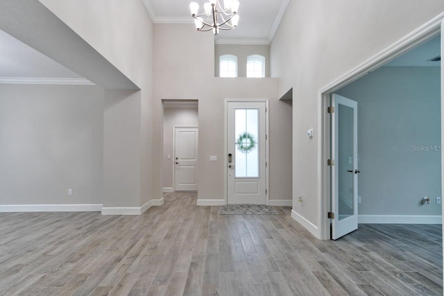 1068 Sea Shell Ct, Daytona Beach, FL 32124 - entrance foyer featuring a healthy amount of sunlight, crown molding, light wood-style flooring, and baseboards