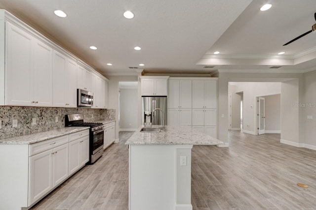 1068 Sea Shell Ct, Daytona Beach, FL 32124 - kitchen featuring light wood-style flooring, a sink, stainless steel appliances, white cabinetry, and backsplash