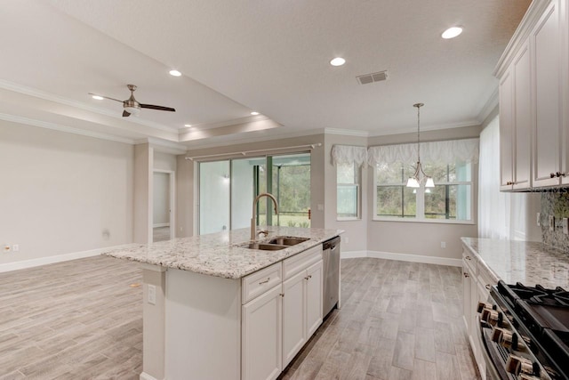 1068 Sea Shell Ct, Daytona Beach, FL 32124 - kitchen featuring a raised ceiling, visible vents, appliances with stainless steel finishes, a sink, and light wood-type flooring