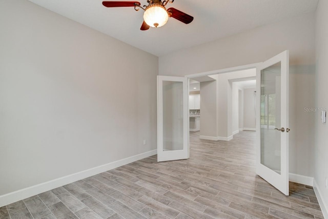 1068 Sea Shell Ct, Daytona Beach, FL 32124 - unfurnished room with baseboards, french doors, and light wood-style floors