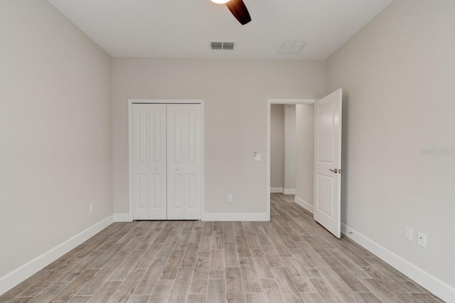 1068 Sea Shell Ct, Daytona Beach, FL 32124 - unfurnished bedroom featuring a closet, visible vents, light wood-style floors, a ceiling fan, and baseboards