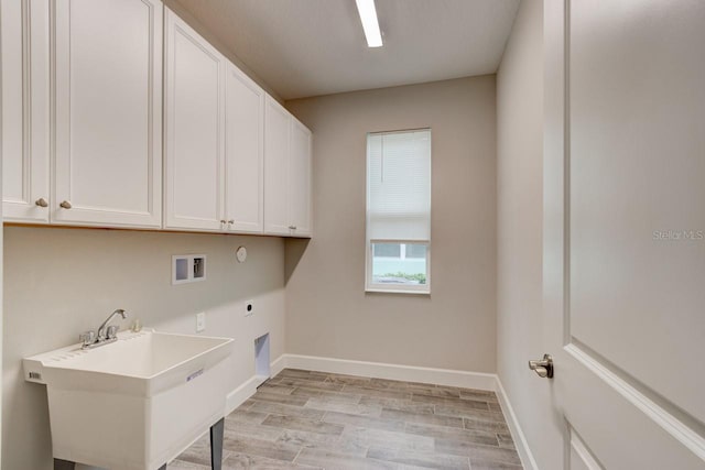 1068 Sea Shell Ct, Daytona Beach, FL 32124 - laundry area featuring washer hookup, cabinet space, light wood-style flooring, a sink, and electric dryer hookup