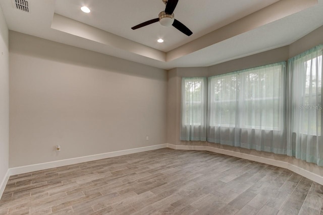 1068 Sea Shell Ct, Daytona Beach, FL 32124 - empty room with wood finished floors, a raised ceiling, visible vents, and baseboards