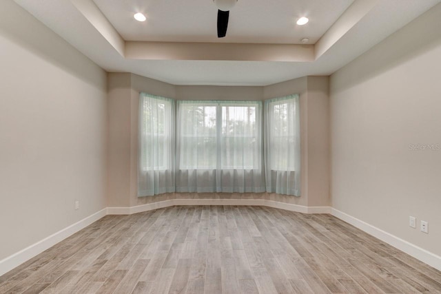 1068 Sea Shell Ct, Daytona Beach, FL 32124 - unfurnished room featuring ceiling fan, a tray ceiling, wood finished floors, and baseboards