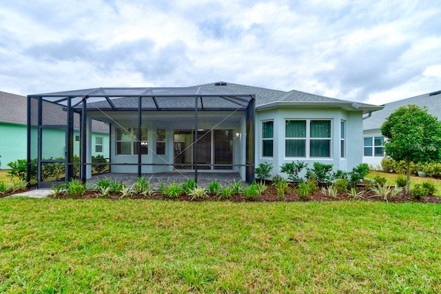 1068 Sea Shell Ct, Daytona Beach, FL 32124 - rear view of house with glass enclosure, stucco siding, a patio, and a yard