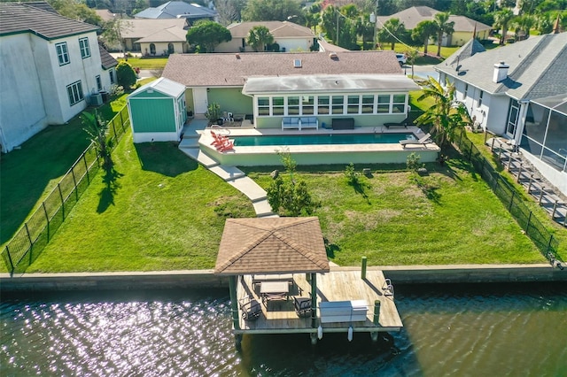 back of property featuring a water view, a fenced backyard, a residential view, and a patio