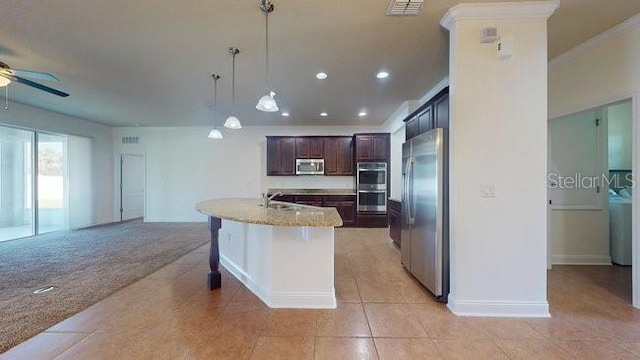 kitchen featuring ceiling fan, stainless steel appliances, a kitchen breakfast bar, open floor plan, and pendant lighting