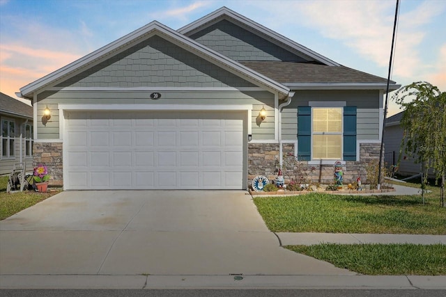 craftsman house with an attached garage, stone siding, and driveway