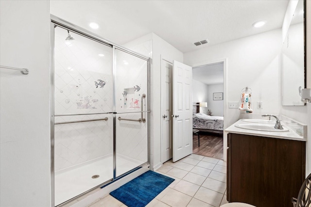 bathroom with visible vents, tile patterned floors, ensuite bathroom, a shower stall, and a sink