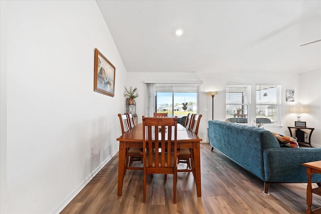 dining area featuring dark wood-type flooring and baseboards