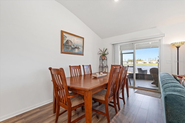 dining room featuring lofted ceiling, baseboards, and dark wood-style flooring