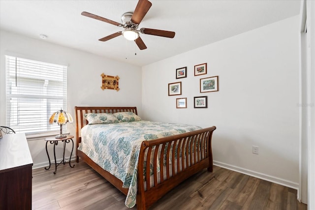 bedroom with ceiling fan, baseboards, and wood finished floors