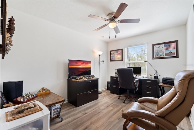 home office with ceiling fan, light wood-style flooring, and baseboards