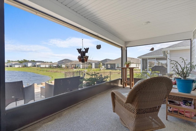 sunroom / solarium featuring a residential view