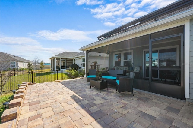 view of patio with a sunroom, fence, and an outdoor living space