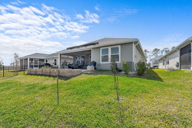 rear view of property with a yard, a patio area, and fence