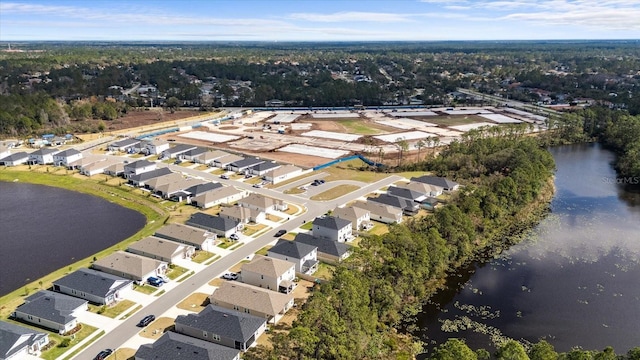 bird's eye view with a water view and a residential view