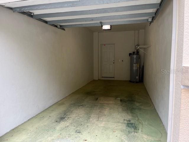 garage featuring a garage door opener and electric water heater