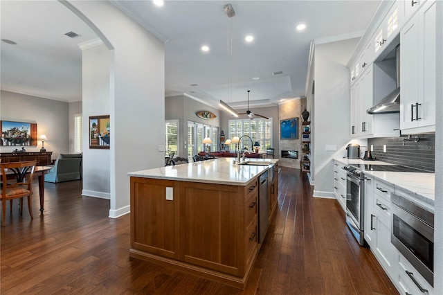 kitchen featuring white cabinets and a kitchen island with sink