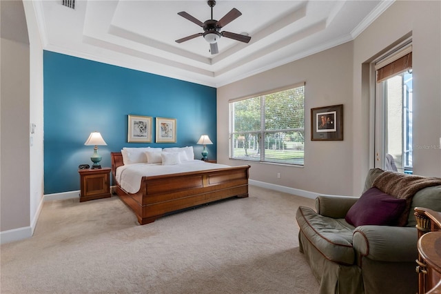 bedroom featuring a tray ceiling, light colored carpet, and baseboards