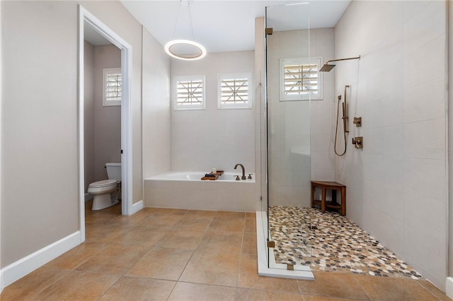 bathroom with toilet, a stall shower, a healthy amount of sunlight, and a bath