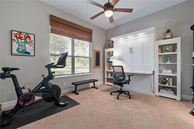 workout area featuring light carpet, a ceiling fan, and baseboards