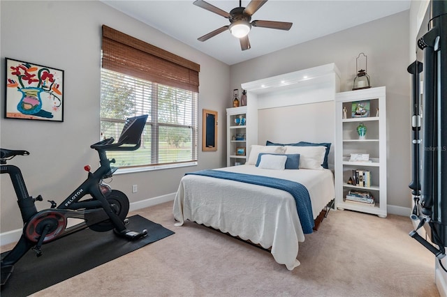 bedroom with light carpet, ceiling fan, and baseboards