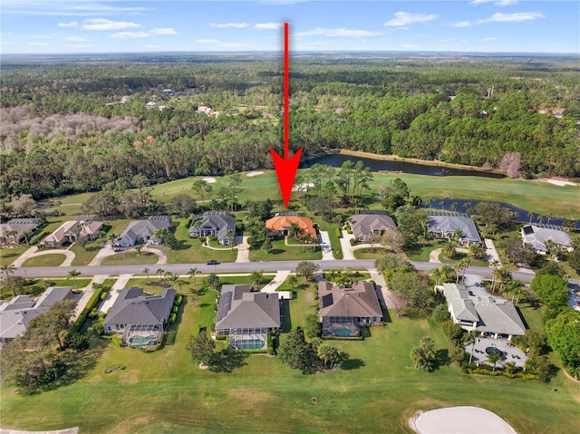 drone / aerial view featuring a residential view and a view of trees