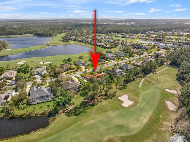 aerial view with golf course view, a water view, and a residential view