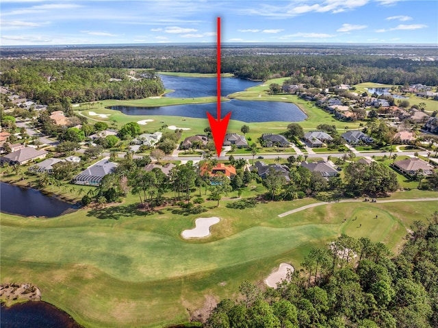 birds eye view of property with a water view and golf course view