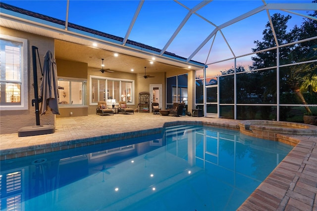 view of swimming pool featuring a patio, a lanai, an outdoor living space, a pool with connected hot tub, and a ceiling fan