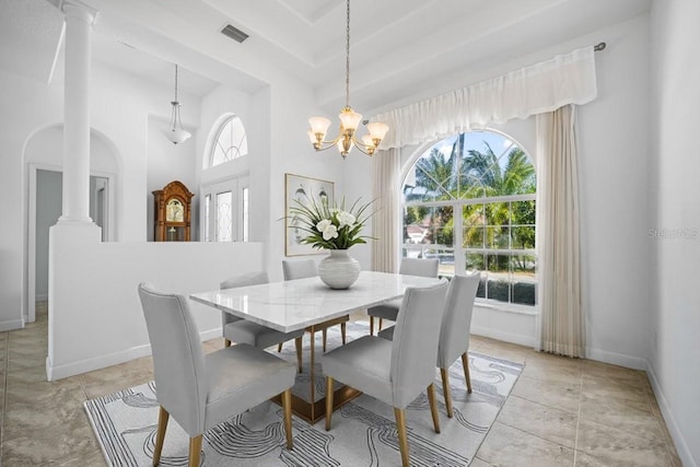 dining space with a healthy amount of sunlight, visible vents, baseboards, and ornate columns