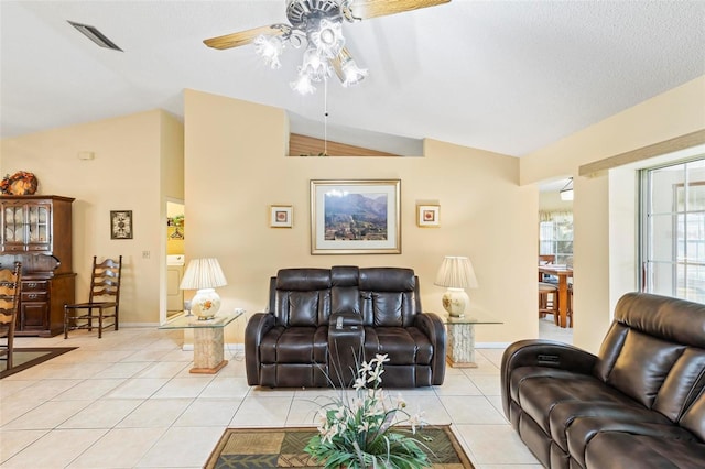 living area featuring light tile patterned floors, baseboards, visible vents, a ceiling fan, and lofted ceiling