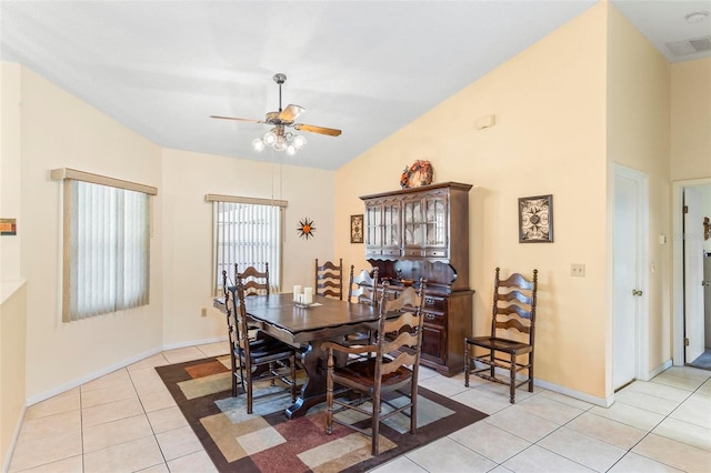dining space featuring light tile patterned floors, lofted ceiling, visible vents, a ceiling fan, and baseboards