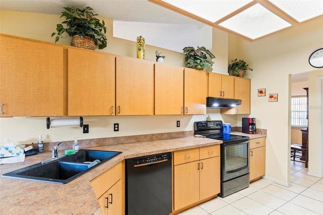 kitchen featuring light tile patterned floors, under cabinet range hood, a sink, light countertops, and black appliances