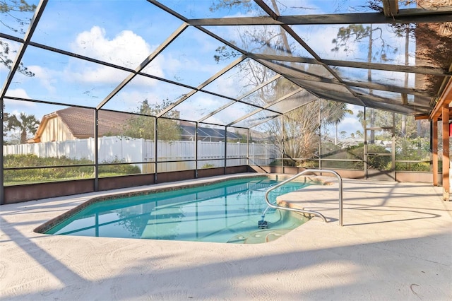 view of pool featuring a patio area, fence, glass enclosure, and a fenced in pool