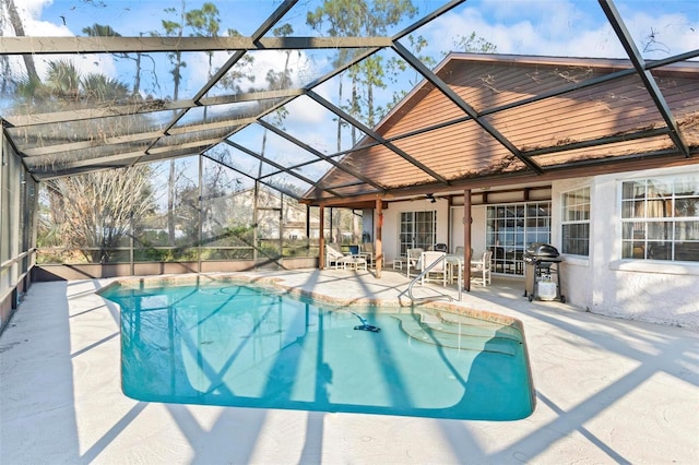 outdoor pool featuring area for grilling, a patio area, and a lanai