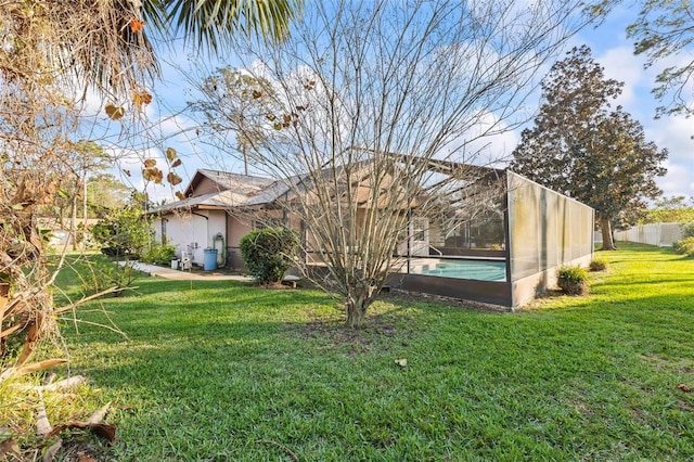 view of yard featuring a lanai and a fenced in pool