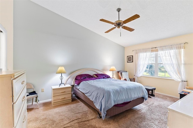 carpeted bedroom featuring a ceiling fan, lofted ceiling, a textured ceiling, and baseboards