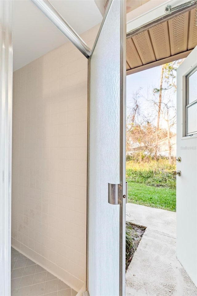 doorway to outside with tile patterned floors