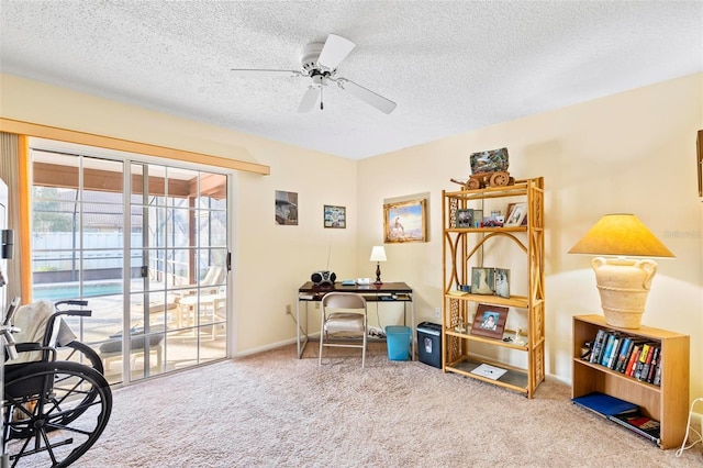 interior space featuring ceiling fan, a textured ceiling, carpet, and baseboards