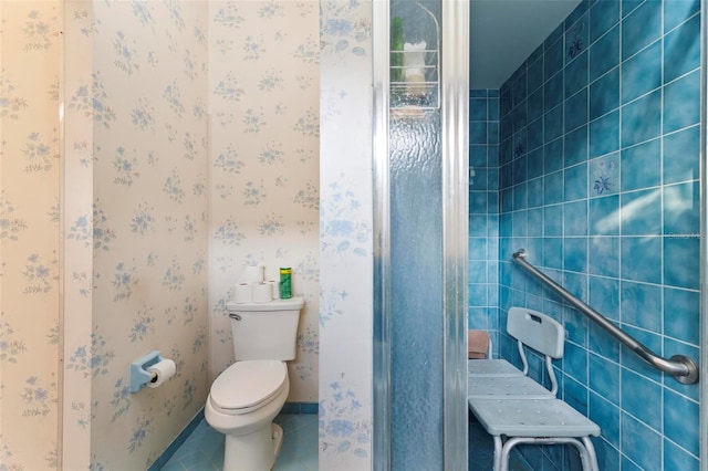 bathroom featuring toilet, baseboards, and tile patterned floors