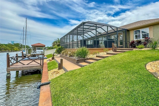 exterior space with a lanai, a water view, boat lift, and a boat dock