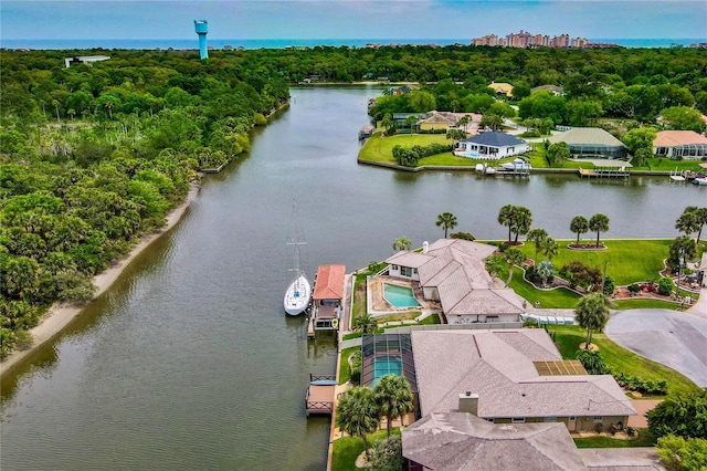 birds eye view of property with a water view and a forest view