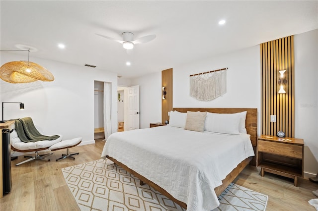 bedroom with light wood-style floors, visible vents, a closet, and recessed lighting